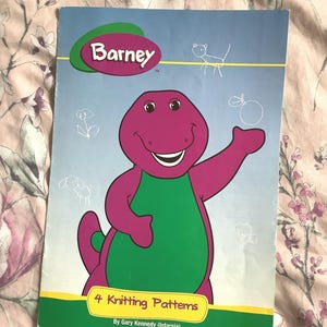May include: A purple dinosaur named Barney is on the cover of a book titled "4 Knitting Patterns" by Gary Kennedy (intarsia).