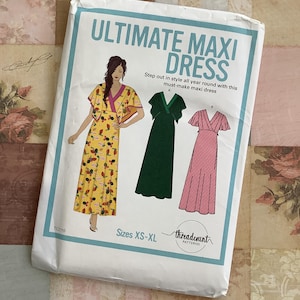 May include: A white package featuring the text "ULTIMATE MAXI DRESS" with illustrations of maxi dresses. The package includes the text "Step out in style all year round with this must-make maxi dress" and "Sizes XS-XL".