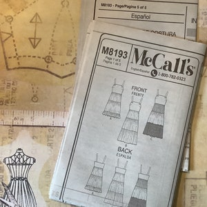 May include: A sewing pattern for a tiered dress with a sleeveless design. The pattern is for McCall's pattern number M8193 and is available in English and Spanish. The pattern includes instructions for both the front and back of the dress.