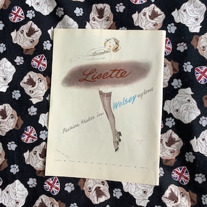 May include: A vintage advertisement for Lisette Wolsey nylons featuring a woman in a white dress and black heels. The ad features the text "Fashion Shades in Lisette Wolsey nylons" and lists various colours of nylons.