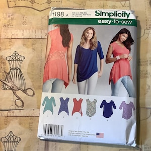 May include: Simplicity sewing pattern 1198 A, showing images of women's tops. The pattern includes various top designs, with the words "easy-to-sew" displayed. The pattern is designed and printed in the USA.