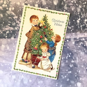 RARO biglietto vuoto vintage degli anni '70 circa 'Auguri di Natale' disegnato da Eva Harta Bambini carini che decorano un albero di Natale e un dolce saluto