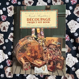 May include: A softcover book titled Milner Craft Series Nerida Singleton's DÉCOUPAGE PROJECT KIT BOOK With images, papers and projects. The cover features a collection of decoupage items including round boxes, a small box, and decorative cards.