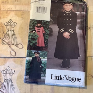 May include: A vintage sewing pattern for children's coats, with a girl in a black coat with gold buttons and white stripes. The pattern is labelled "Little Vogue" and includes images of different coat styles.