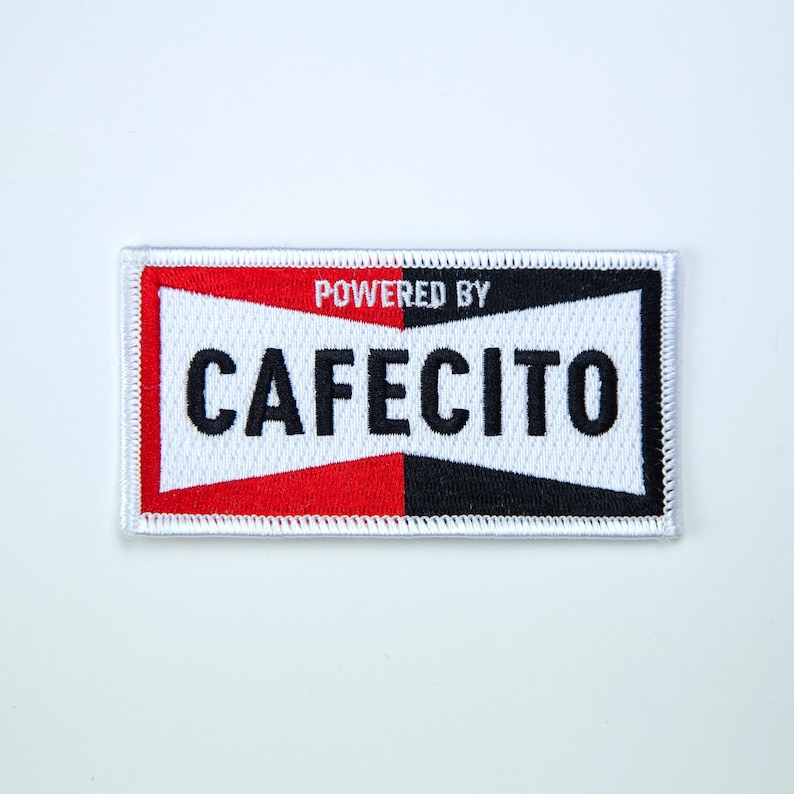 May include: White, red, and black embroidered patch with the text "POWERED BY CAFEICITO" in black.