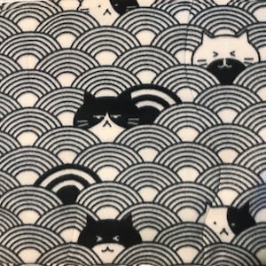 May include: Black and white fabric with a repeating pattern of stylized cats peeking out from behind a wave design. The cats have black eyes and white whiskers.