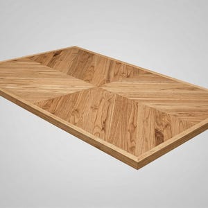 May include: Rectangular wooden tabletop with a light brown finish. The tabletop features a geometric pattern of angled wood grain, framed by a darker border. The design is symmetrical and modern, suitable for a dining or coffee table.