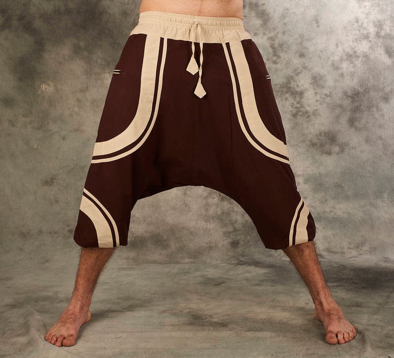 Puede incluir: Pantalones de color marr&oacute;n y beige con estampado, de corte holgado y cintura con cord&oacute;n.