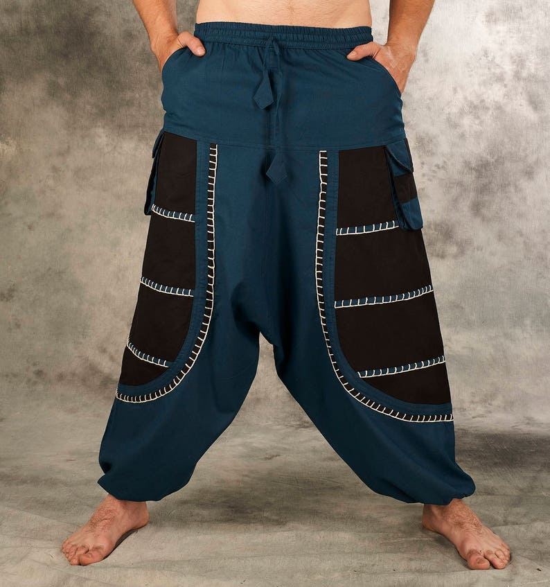 May include: Blue and black pants with decorative stitching. The pants have a wide leg and a drawstring waist.