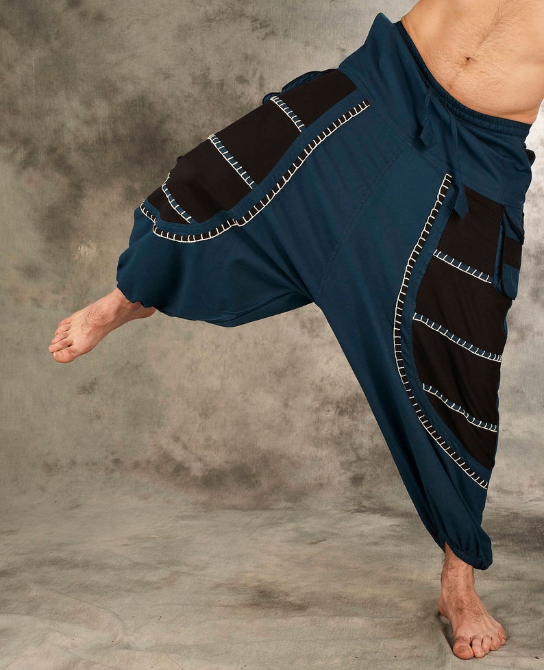 May include: Blue and black pants with white stitching. The pants have a loose, flowing fit and are made of a lightweight fabric.