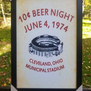 May include: A vintage-style poster advertising a 10&cent; beer night at Cleveland Municipal Stadium on June 4, 1974. The poster features a black and white illustration of the stadium.