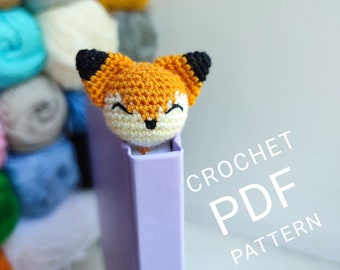 May include: Crochet PDF pattern for a cute orange and white fox bookmark. The fox has black ears and a black nose. The pattern is available for download.