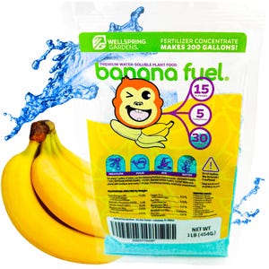 May include: A blue and yellow pouch of banana fuel fertilizer concentrate. The pouch features a cartoon monkey holding a banana and the text "banana fuel" in a yellow and blue font. The pouch also includes a label with the text "Makes 200 Gallons!" and a guaranteed analysis of the fertilizer. The pouch is sitting on a white background with two yellow bananas in the foreground.