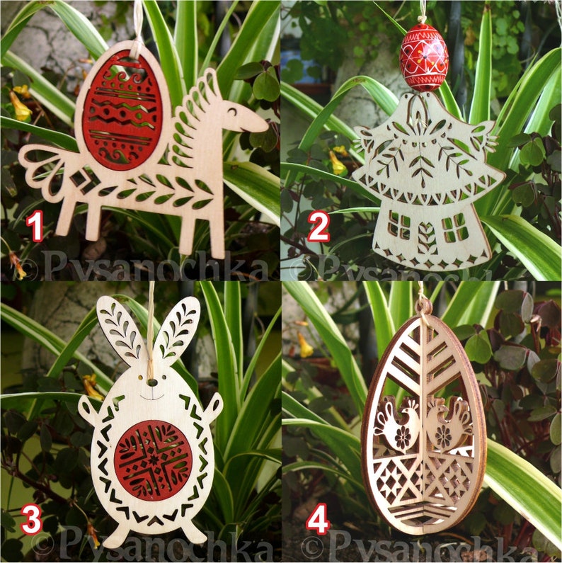 May include: Four wooden Easter ornaments. The ornaments include a horse with an egg, an angel, a bunny, and an egg with birds. Each ornament is made of light-colored wood with red accents and intricate cut-out designs. They hang from a natural twine.