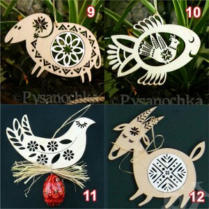 May include: A collection of four wooden ornaments. The ornaments include a sheep, a fish, a bird, and a goat. Each ornament is cut from light-colored wood and features intricate cut-out designs. The ornaments are likely for decoration or crafts.
