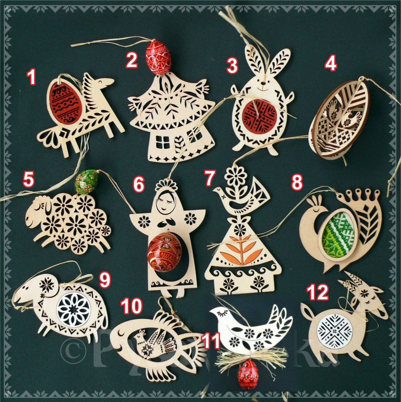 May include: A collection of wooden Easter ornaments in various shapes, including a bird, angel, rabbit, sheep, fish, and goat. Each ornament features intricate cut-out designs and is adorned with painted eggs. The ornaments are strung with twine.