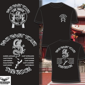 May include: Black t-shirts with a white graphic featuring a dragon, the text "FAR EAST TOUR", and "THE ROCK OKINAWA, JAPAN". The design includes a list of locations. The shirts are displayed on a black background.