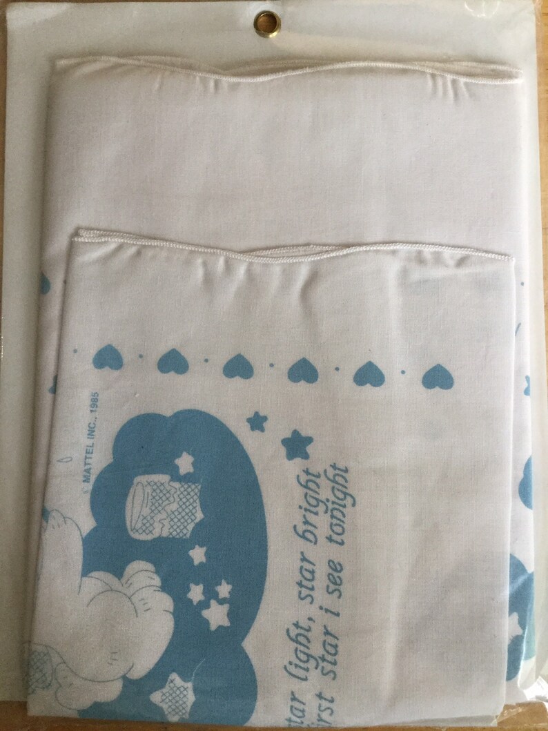 Puede incluir: Juego de cama blanco con un dise&ntilde;o de dibujos animados azul y blanco. El juego incluye una funda de almohada y una s&aacute;bana m&aacute;s grande, ambas con un patr&oacute;n repetido de corazones y estrellas azules. El texto en la funda de almohada dice "star light, star bright, first star I see tonight."