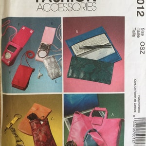 May include: A pattern for McCall's Fashion Accessories, featuring various designs. Includes a pink laptop bag, a green phone case, a red case, a checkbook cover, and a key holder. The pattern number is M5012.