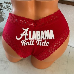May include: Red cotton underwear with white lace trim and the words "Alabama Roll Tide" printed on the front.