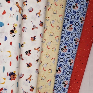 May include: A collection of vintage-style fabric rolls featuring playful patterns. Designs include toy animals, telephones, and geometric shapes in colors like white, yellow, blue, and red. Ideal for quilting or crafting projects.