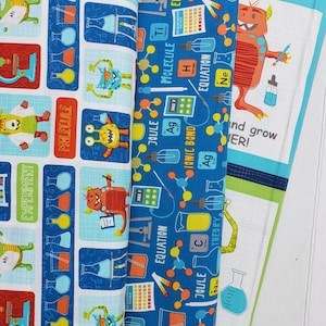 May include: Blue and white fabric with a repeating pattern of monsters, beakers, and science-related words like "molecule", "experiment", "joule", "ionic bond", and "equation".