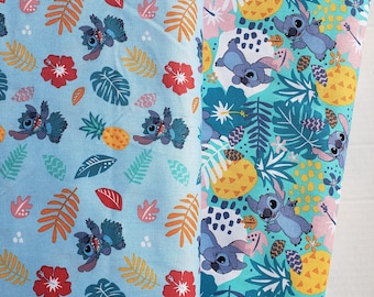 May include: Two pieces of blue and green fabric with a repeating pattern of Stitch from Lilo & Stitch, pineapples, and tropical leaves.