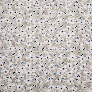 May include: A beige fabric with a white and blue floral pattern. The flowers are outlined in red.
