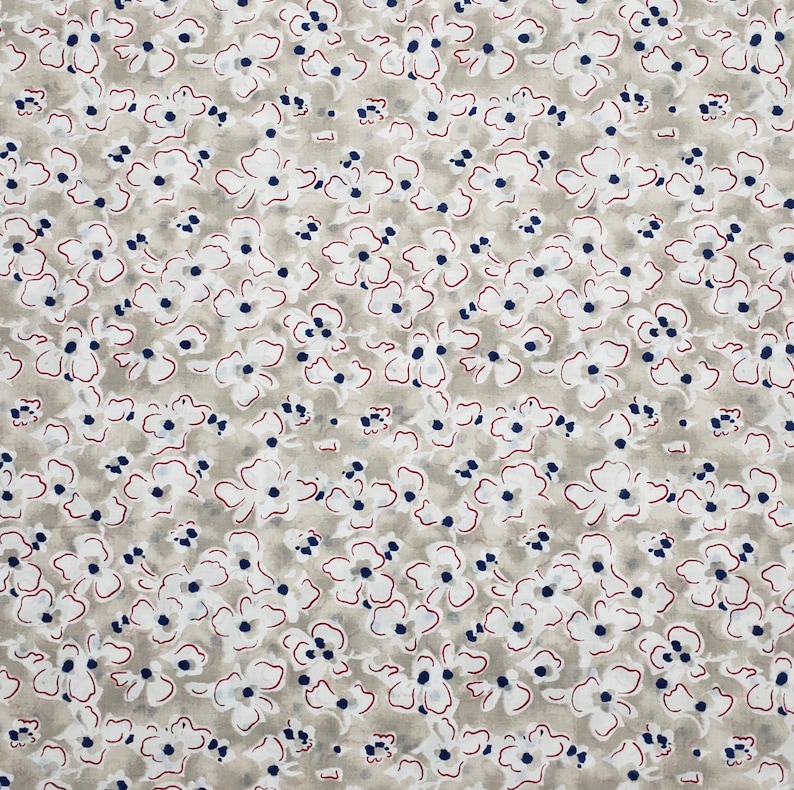 May include: A beige fabric with a white and blue floral pattern. The flowers are outlined in red.