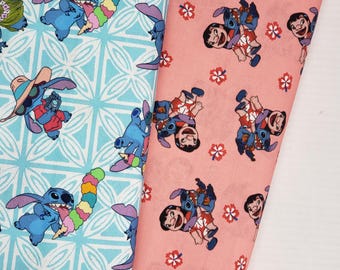 May include: Two pieces of fabric with a blue and pink background. Both fabrics feature a repeating pattern of Stitch from Lilo & Stitch. The blue fabric has a white geometric pattern. The pink fabric has a white flower pattern.