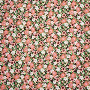 May include: A brown fabric with a repeating pattern of small pink and white flowers. The fabric has a vintage feel.
