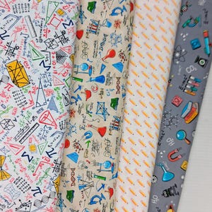 May include: Four vertical strips of fabric featuring science and math themes. The first is white with colorful geometric shapes and equations. The second is beige with laboratory equipment. The third has a repeating pencil pattern. The fourth is gray with science icons.
