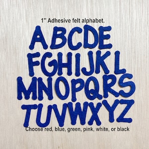 May include: 1 inch adhesive felt alphabet letters in blue. The letters are A, B, C, D, E, F, G, H, I, J, K, L, M, N, O, P, Q, R, S, T, U, V, W, X, Y, and Z. Choose red, blue, green, pink, white, or black.
