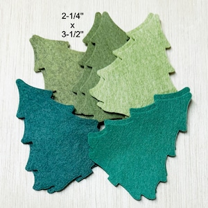 May include: A collection of felt Christmas tree cutouts in various shades of green and teal. The trees measure 2-1/4" x 3-1/2". These craft supplies are ideal for holiday decorations and DIY projects.