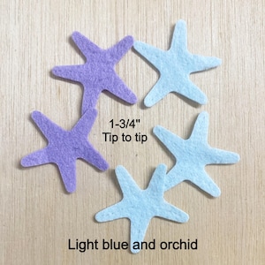May include: Five felt starfish shapes in light blue and orchid purple colors. The starfish are arranged in a cluster. Text on the image reads 1-3/4" Tip to tip and Light blue and orchid, indicating the size and color of the felt cutouts.