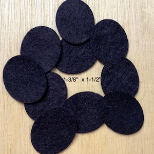 May include: Nine black felt circles, each measuring 1-3/8" x 1-1/2", arranged in a circular pattern on a wooden surface.