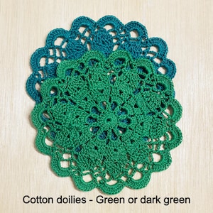 May include: Two crocheted doilies, one green and one dark green, with intricate patterns. Cotton doilies - Green or dark green.