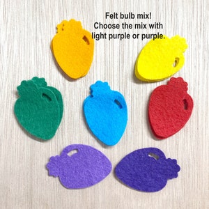 May include: Felt bulb mix! Choose the mix with light purple or purple.  A set of six felt light bulb shapes in various colors: green, blue, red, yellow, and two shades of purple.