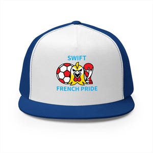 May include: A white and blue trucker hat featuring a graphic of a soccer ball, a yellow rooster head, and a red trophy. The text SWIFT is printed above the graphic, and the text FRENCH PRIDE is printed below the graphic in light blue letters.