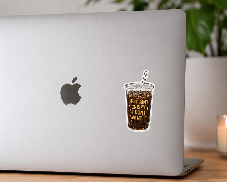 May include: A die-cut sticker featuring a clear plastic cup filled with dark brown soda, ice cubes, and a straw. The text on the cup reads IF IT AINT CRISPY I DONT WANT IT in yellow capital letters, accented by small yellow four-pointed stars.