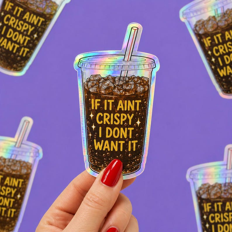 May include: A holographic sticker shaped like a clear plastic cup filled with dark brown soda, ice cubes, and a straw. The text IF IT AINT CRISPY I DONT WANT IT is printed in yellow on the cup, surrounded by small star icons and bubbles.