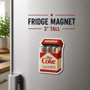 May include: A fridge magnet featuring a Diet Coke box with three Diet Coke cans inside. The magnet is 3 inches tall and has the text "FRIDGE MAGNET" and "JUST A LITTLE SOMETHING TO TAKE THE EDGE OFF".