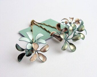 Three hair clips with delicate blossoms