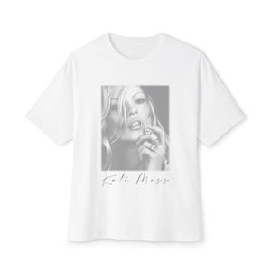 May include: White t-shirt with a black and white image of Kate Moss. The image is a close-up of her face and includes the name "Kate Moss" in a cursive font at the bottom of the image.