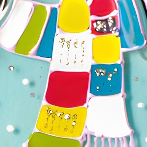 May include: A colorful scarf with a patchwork design. The scarf is made of different colored squares, including red, yellow, blue, green, and white. The scarf has a fringe on the bottom.