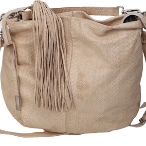May include: A light beige leather handbag with a fringe detail and a long shoulder strap. The bag has a snakeskin pattern.