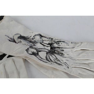 May include: A pair of white leather gloves with a black and white ink drawing of a woman in a dress on the back of one glove.