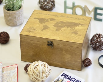 May include: A wooden box with a world map and compass design engraved on the lid. The box has a metal clasp and the text "I haven't been everywhere, but it's on my list". Decorative items and a Prague city guide surround the box.