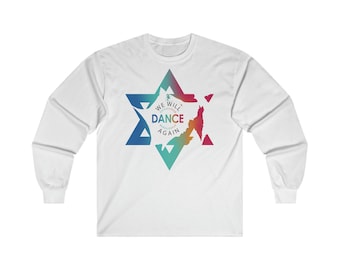 May include: White long-sleeved t-shirt featuring a colourful graphic of a six-pointed star with the text "WE WILL DANCE AGAIN" inside.