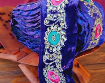 Purple braid on velvet with colored embroidery and rhinestones, traditional decoration of Afghan clothing, baludji, Indian lace.
